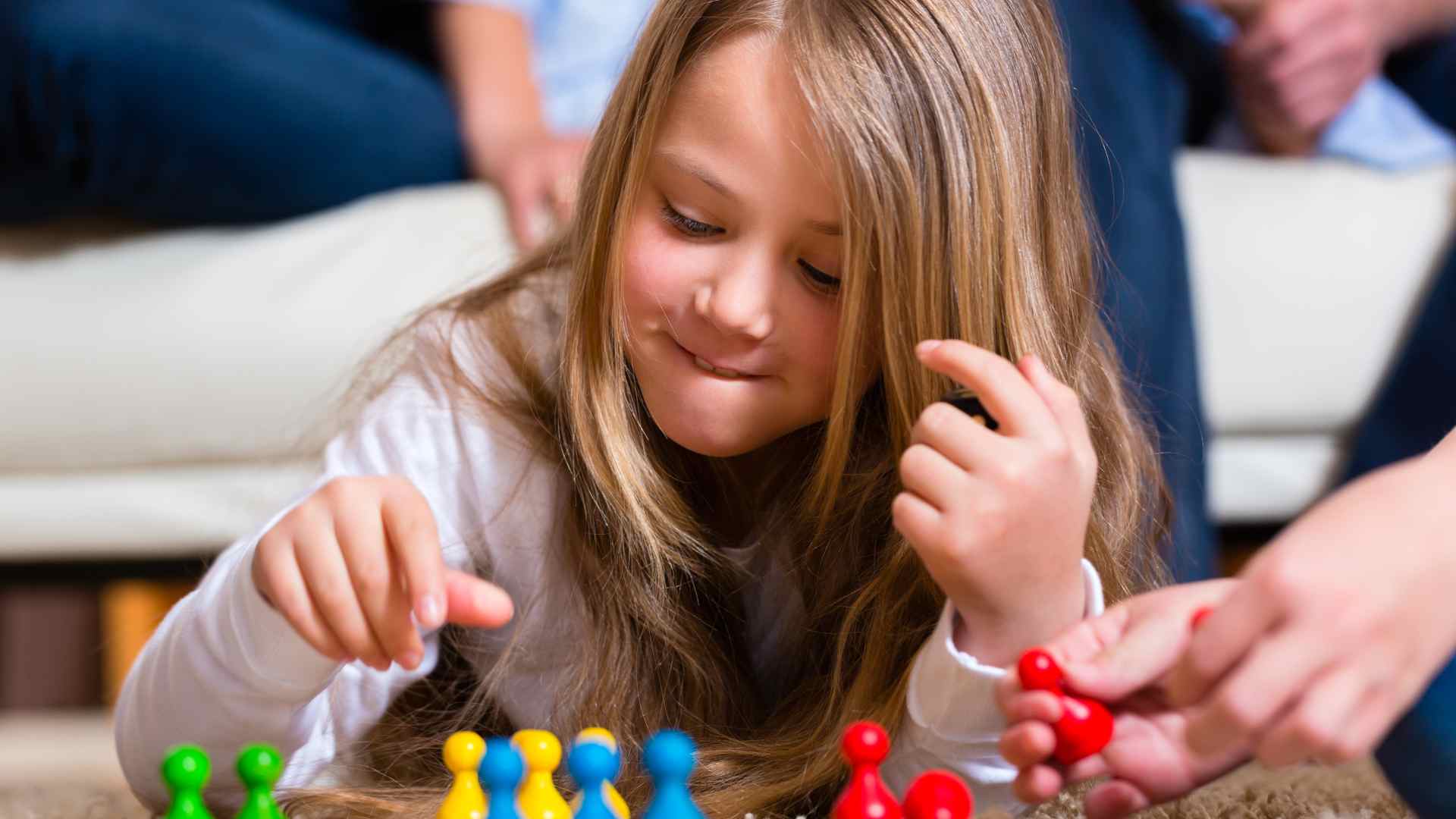 Child climbing a playground structure with visible guardrails while a parent supervises nearby