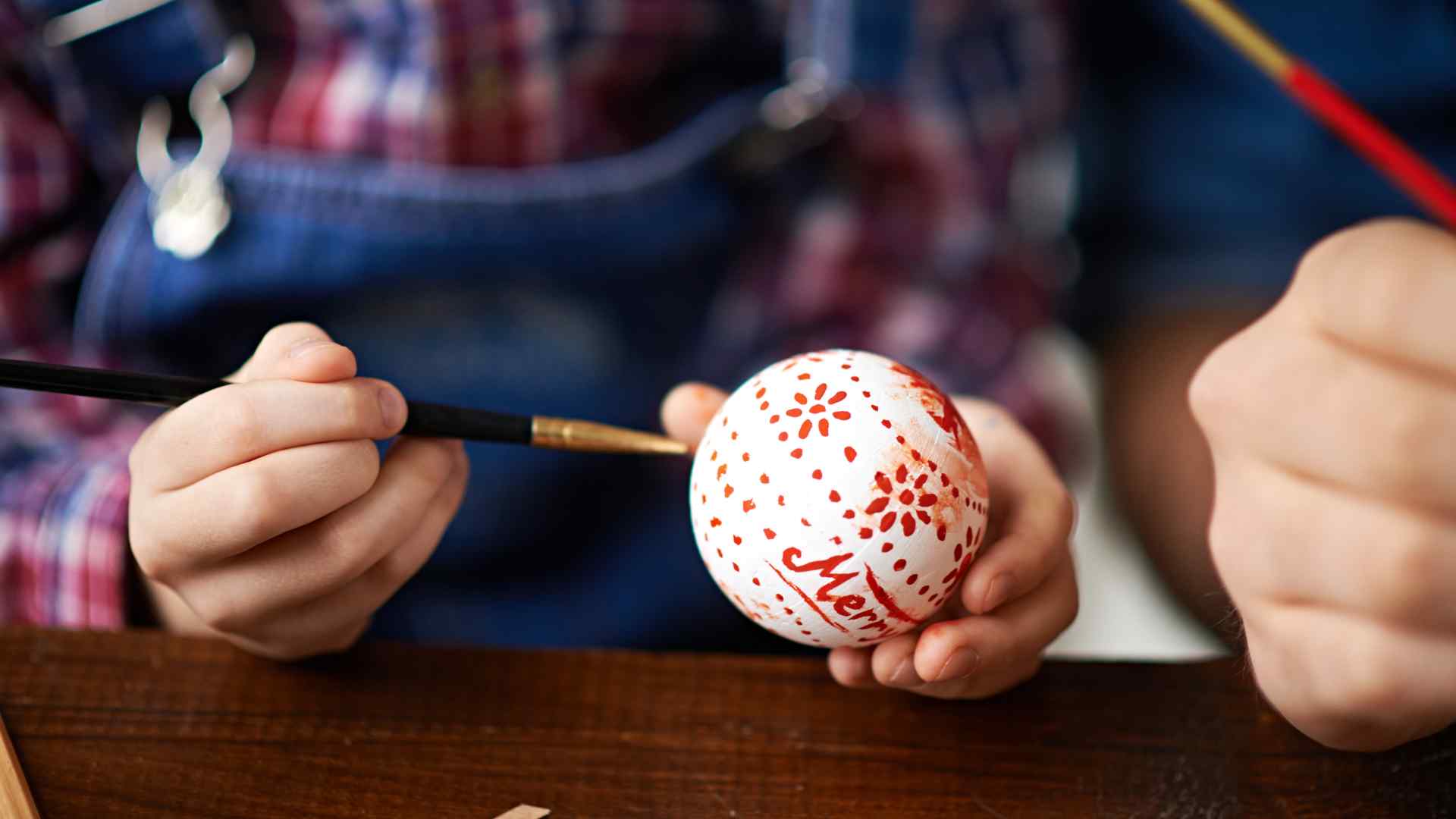 Kids playing a dreidel game with gelt coins on a table decorated for Hanukkah