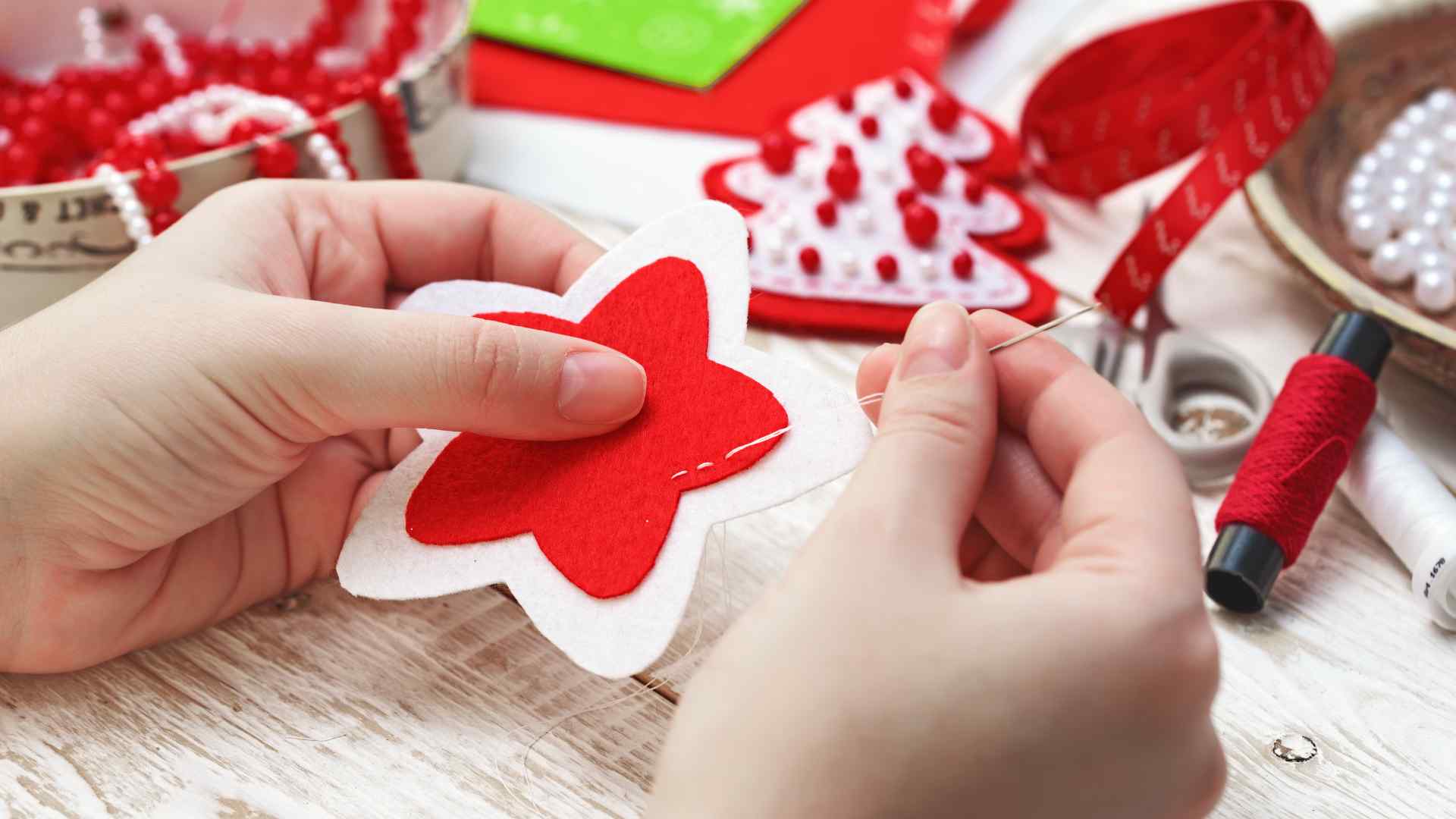 Close up of hands creasing the nose of a paper airplane dart