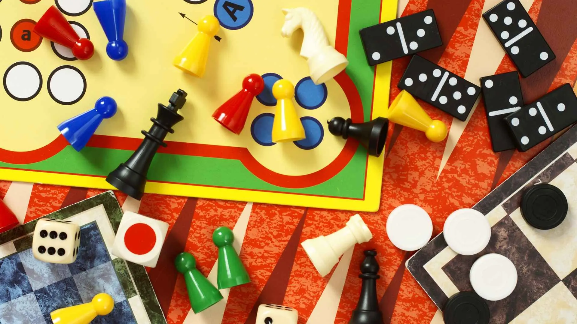 A 5-year-old exploring outside with a magnifying glass and a small bug-catching kit
