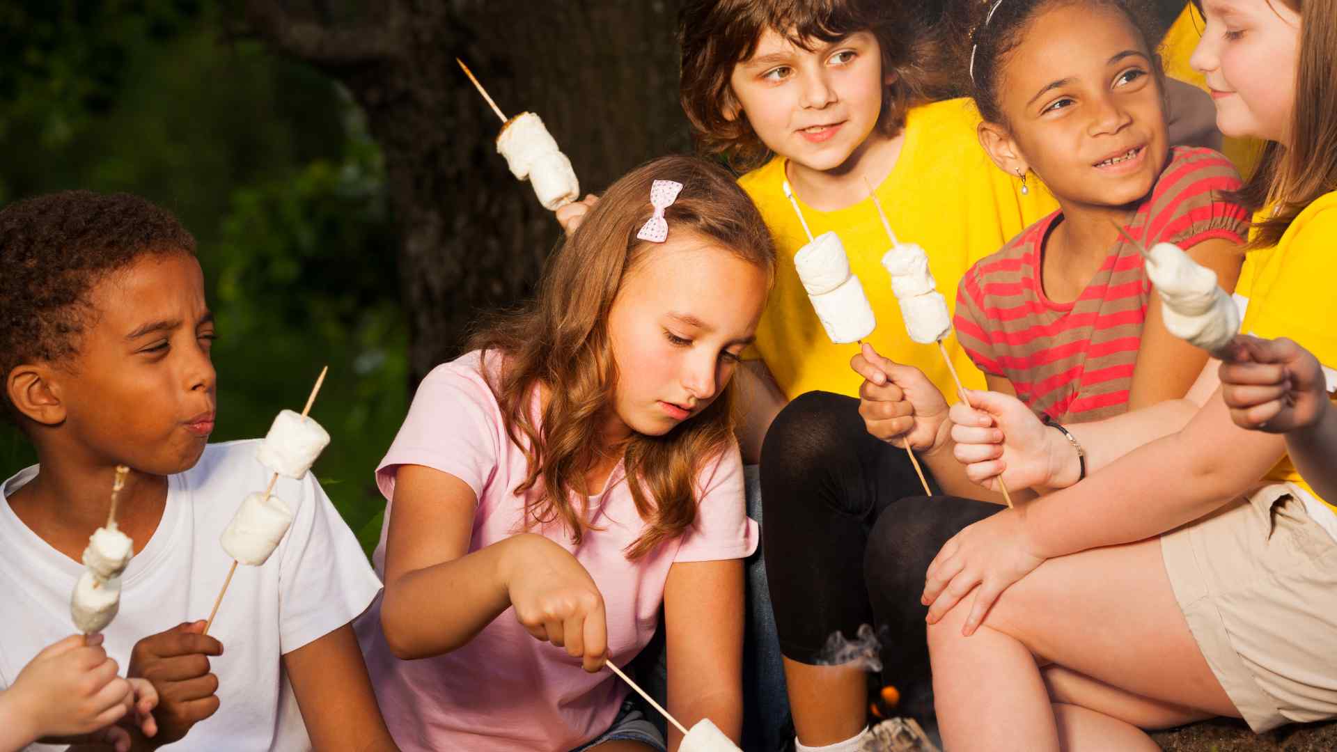 Kids doing daytime camp activities like a nature scavenger hunt instead of using screens
