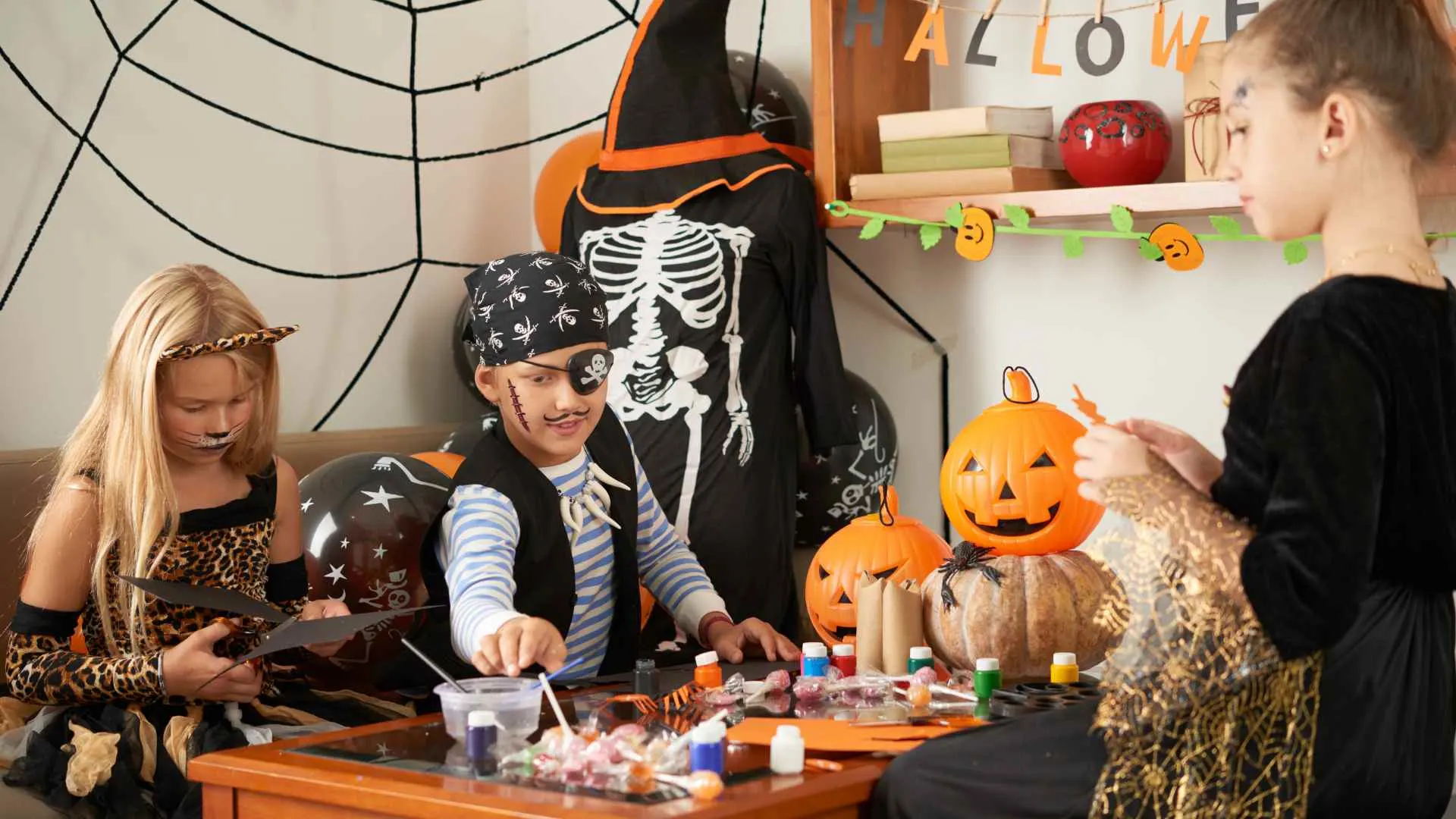 Kids at a craft table making clay animal figures and jewelry from polymer clay