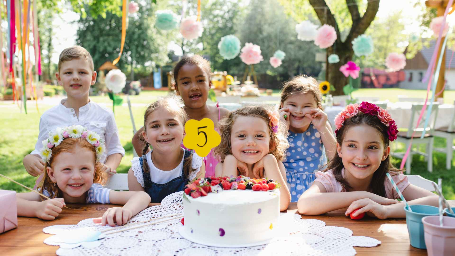 Kids lined up for a backyard relay race game with almost no supplies needed