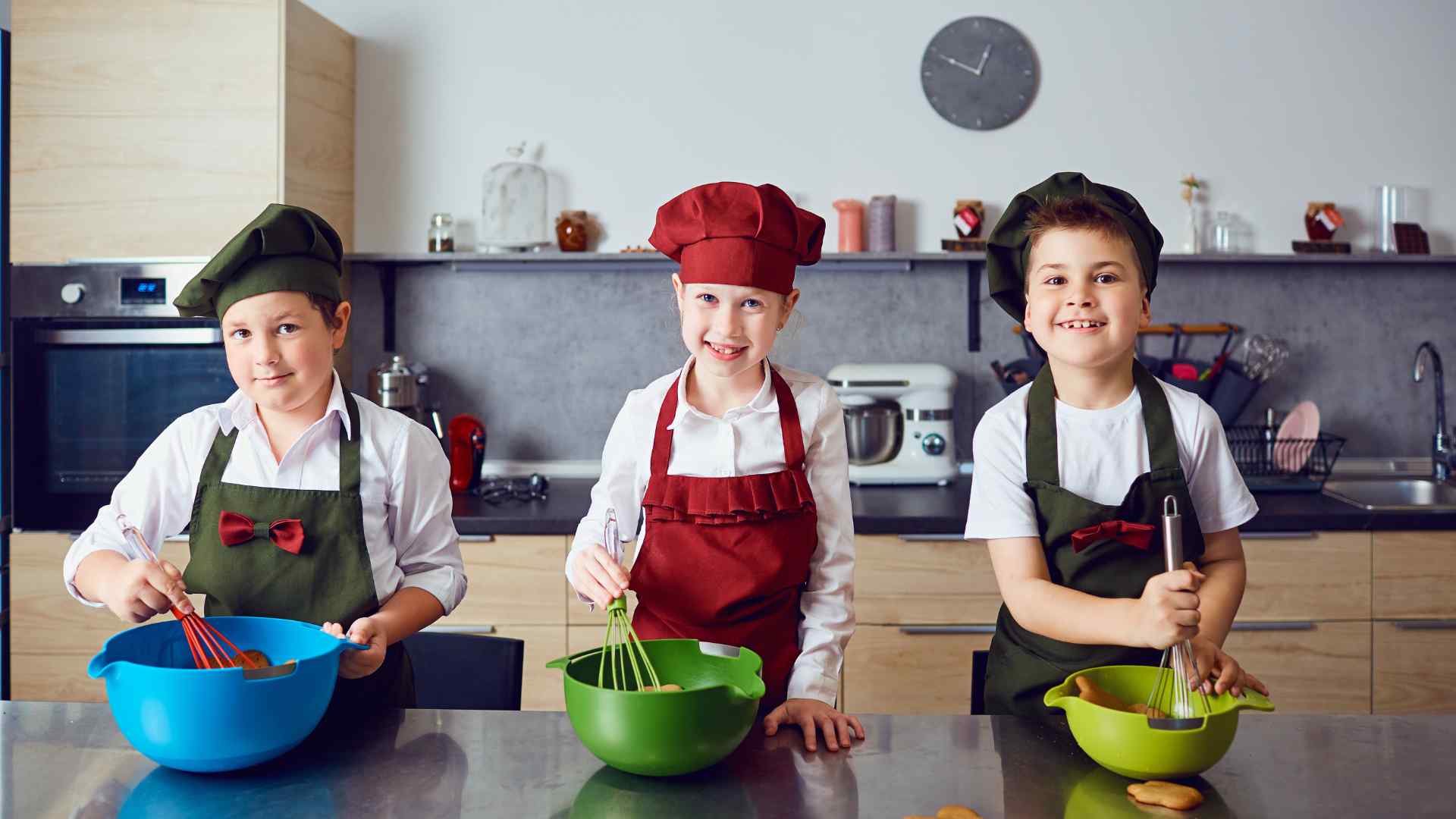 Kid in a kitchen watching a baking soda and vinegar volcano fizz over in a pan