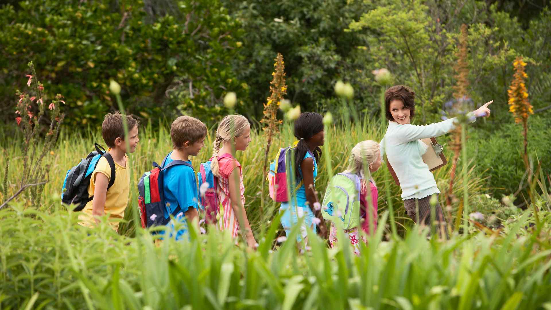 Family walking outside together in nature as part of a daily green time routine