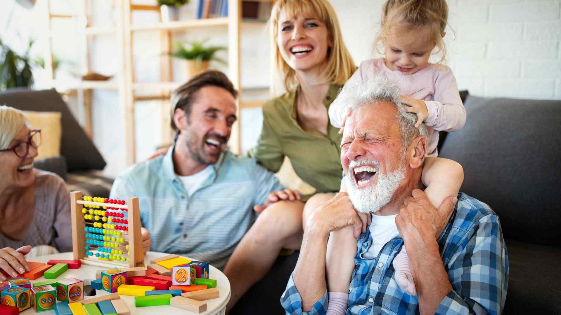 Child playing a whisper-friendly guessing game with a parent while sitting in a pediatrician's waiting room